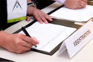 Person signing a registration sheet