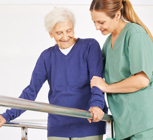 Nurse helping older woman walk