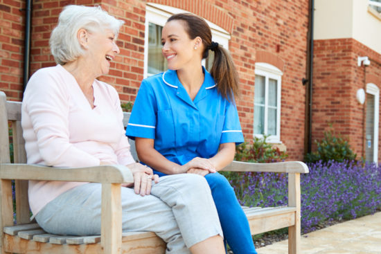 Young and old women sitting on a bench