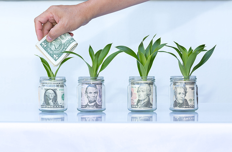 Hand putting money into jar