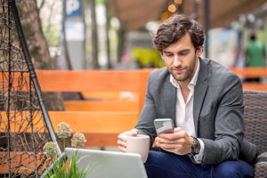 Man working on phone and laptop